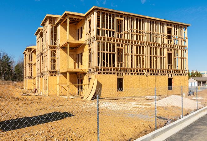 a job site enclosed by temporary chain link fences, ensuring safety for workers and pedestrians in Ridgeland